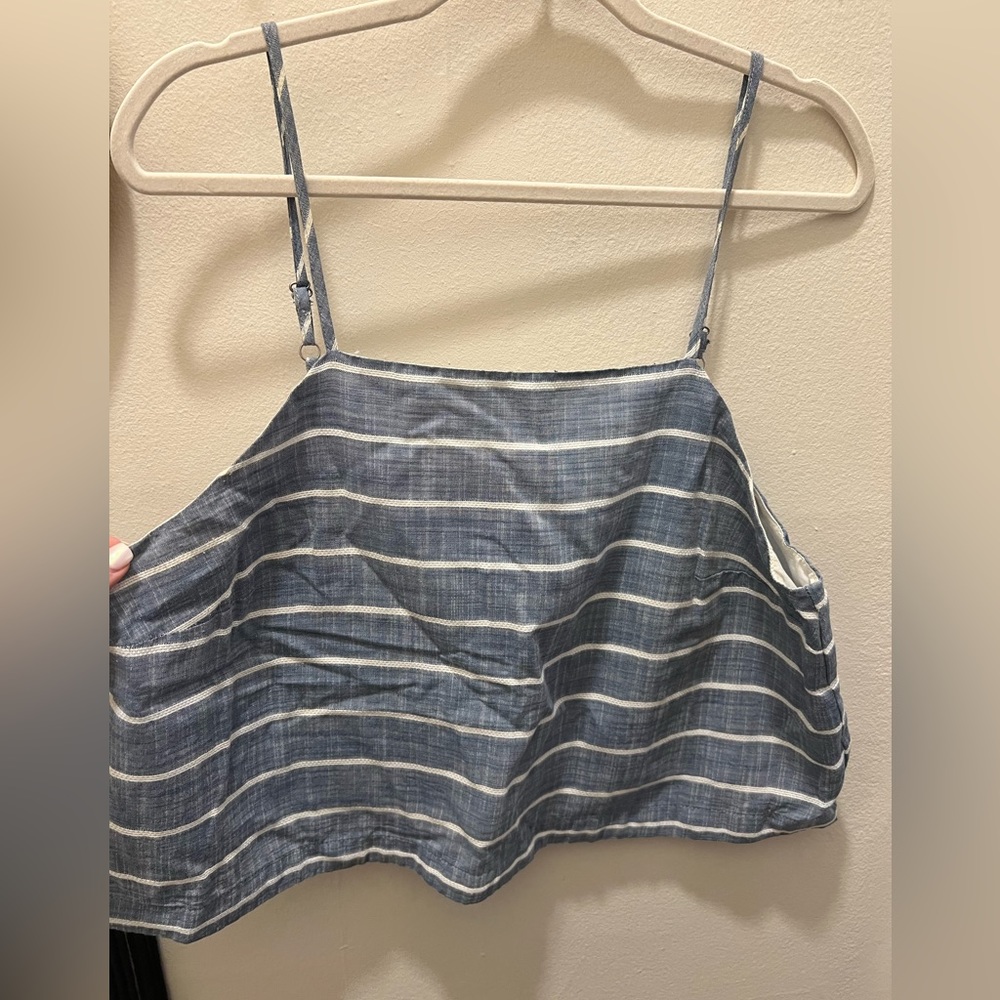 longer crop top with cross over detail in the back. Nautical blue & white